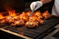 chef flipping jerk-marinated drumsticks on a sizzling grill