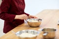 Chef with flour in bowl making batter or dough