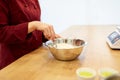 Chef with flour in bowl making batter or dough