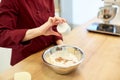 Chef with flour in bowl making batter or dough