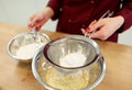 Chef with flour in bowl making batter or dough