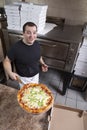 Chef with fresh take out pizza Royalty Free Stock Photo