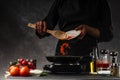 The chef fries the carrots, pouring steam, steam, and freezing in the pan onto a hot pan. Cooking and recipe book. Restaurant