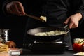 Chef fries onions in a pan, against the background of ingredients. Home recipe book, delicious food, gastronomy