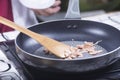 Chef frying bacon in the pan Royalty Free Stock Photo