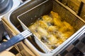 Chef Frying Buffalo Wing Chicken with Fried Machine