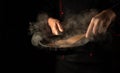 The chef is frying burger cutlets in a frying pan. Close-up of a cook hands with a hot pan in the kitchen. Free space for Royalty Free Stock Photo