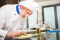 Chef garnishing a dish Royalty Free Stock Photo