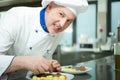 Chef garnishing a dish Royalty Free Stock Photo