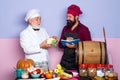 Chef garnishing food in the kitchen. Chef leaning on the counter with a dish in a commercial kitchen. Royalty Free Stock Photo