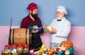 Chef garnishing food in the kitchen. Chef leaning on the counter with a dish in a commercial kitchen. Royalty Free Stock Photo