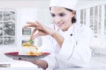 Chef garnishing food with parsley Royalty Free Stock Photo