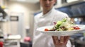 Chef garnishing salads in the kitchen garnishing their salads Royalty Free Stock Photo