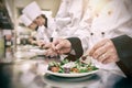 Chef garnishing salads Royalty Free Stock Photo