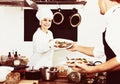 Chef giving salad to waitress Royalty Free Stock Photo