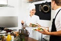 Chef giving salad to waitress Royalty Free Stock Photo