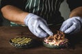 chef in gloves prepares a beef brisket burger close-up Royalty Free Stock Photo