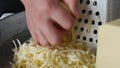 Chef grating cheese for pizza, close up. Royalty Free Stock Photo