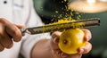 Chef grating fresh lemon zest with microplane grater in professional kitchen Royalty Free Stock Photo