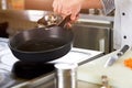 Chef greasing pan with oil.