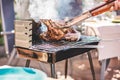 Chef grill t-bone steaks at barbecue dinner outdoor - Man cooking meat for a family bbq meal outside in backyard garden - Summe