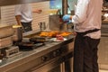 The chef preparing beef meat in barbecue restaurant`s kitchen Royalty Free Stock Photo