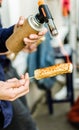 A chef grilling cheese with a kitchen gas torch at a food market