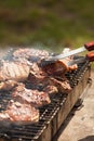 Chef grilling pork steak on flame Royalty Free Stock Photo