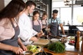 Chef and group of young people during cooking classes