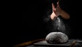 Chef hand clap with splash of white flour and black background with copy space. woman`s hands Making bread Royalty Free Stock Photo