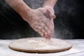 Chef hand clap with splash of white flour on black background. Hands in flour Royalty Free Stock Photo