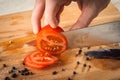 Chef Hand and Knife Slicing Tomato Royalty Free Stock Photo