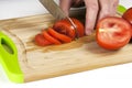 Chef Hand and Knife Slicing Tomato Royalty Free Stock Photo