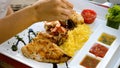 Chef hand squeeze lemon juice to seafood platter with charcoal grilled shrimps Royalty Free Stock Photo