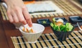 Chef hand picking up a crab stick to make sushi Royalty Free Stock Photo