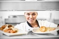 Chef handing dinner plates through order station Royalty Free Stock Photo