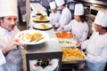 Chef handing dinner plates through order station Royalty Free Stock Photo