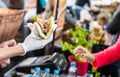 Chef handing a tortilla to a foodie at a street food market