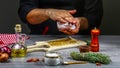 Chef hands cooking Grill striploin steak with spices and vegetables on wooden background. Food concept Royalty Free Stock Photo