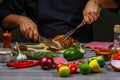 Chef hands cooking Grill striploin steak with spices on wooden background. Food recipe concept Royalty Free Stock Photo