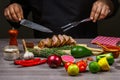 Chef hands Cooking meat steak, vegetables and spices with by chef hands on wooden background. Food recipe concept Royalty Free Stock Photo