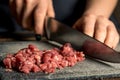 Chef hands cut red meat on a board Royalty Free Stock Photo