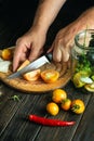 The chef hands cuts a tomato on a kitchen cutting board. Peasant food. Recipe for restaurant and hotel Royalty Free Stock Photo