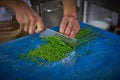 Chef hands cutting chives in restaurant kitchen