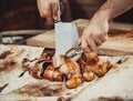 Chef Hands cutting grilled rabbit for steaks with knife on cutting board. Hot Meat dishes. Royalty Free Stock Photo