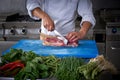Chef hands cutting meat in restaurant kitchen Royalty Free Stock Photo