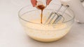 Chef hands delicately pour vanilla extract into a bowl, baking process in motion Royalty Free Stock Photo