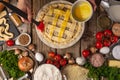 Chef hands eggs the raw pie on wooden table with variety of ingredients background. Concept of cooking process. Backstage of Royalty Free Stock Photo