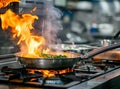 Chef hands keep wok with fire. Closeup chef hands cook food with fire. Chef man burn food at professional kitchen. Royalty Free Stock Photo