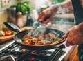 Chef hands keep wok with fire. Closeup chef hands cook food with fire. Chef man burn food at professional kitchen. Royalty Free Stock Photo